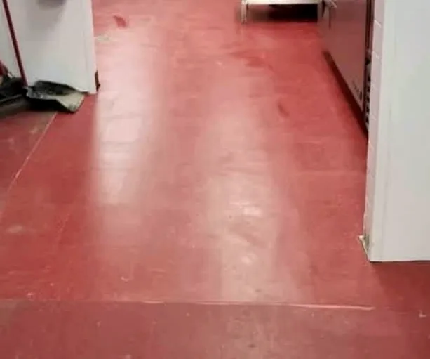 The finished kitchen floor: an even, glossy red coat.